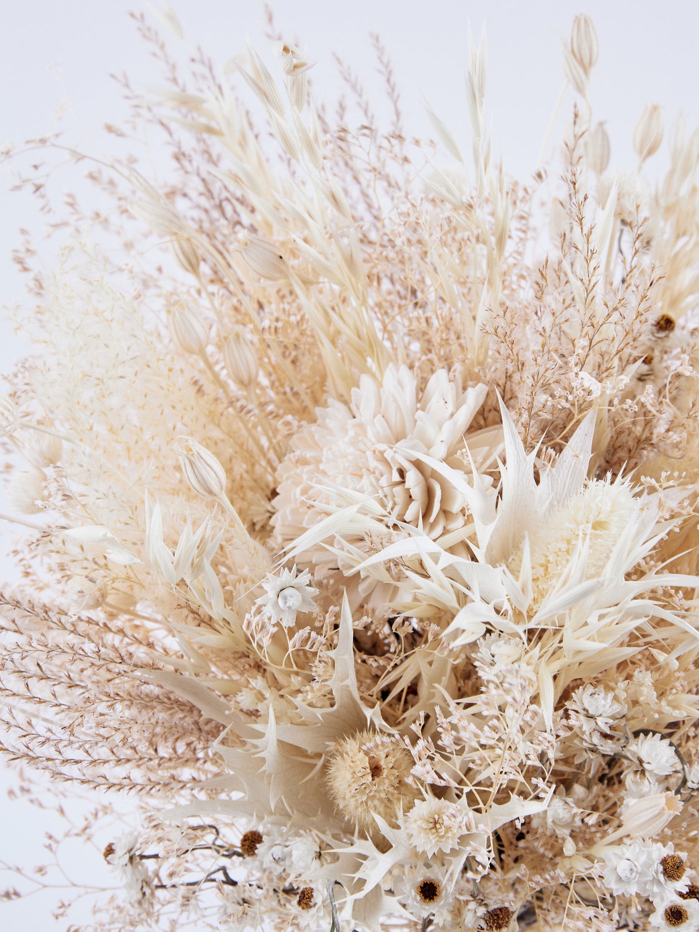 Bridal bouquet with cream dried limoium, eryngium flower and ammobium