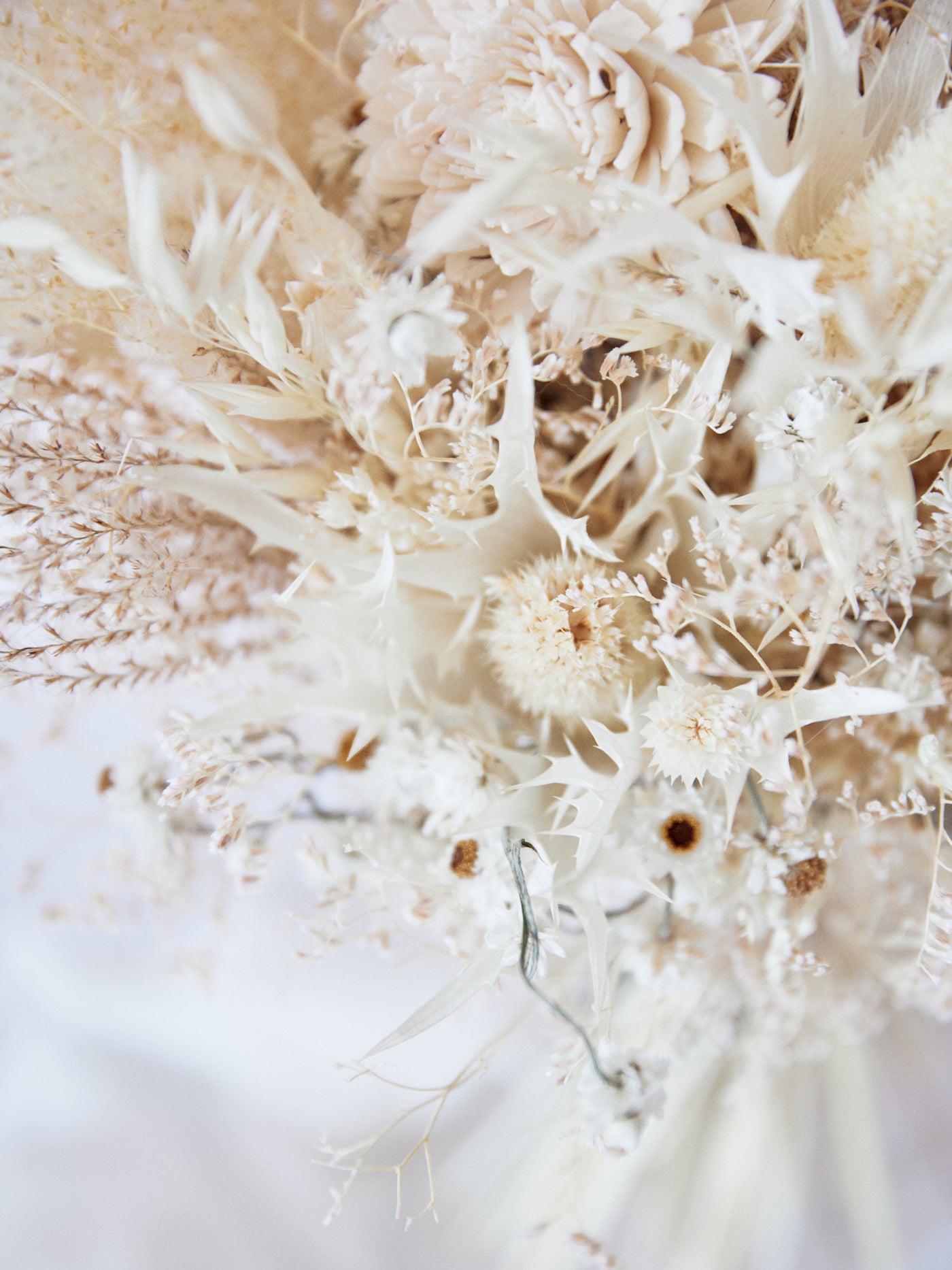 Bridal bouquet with cream dried limoium, eryngium flower and ammobium