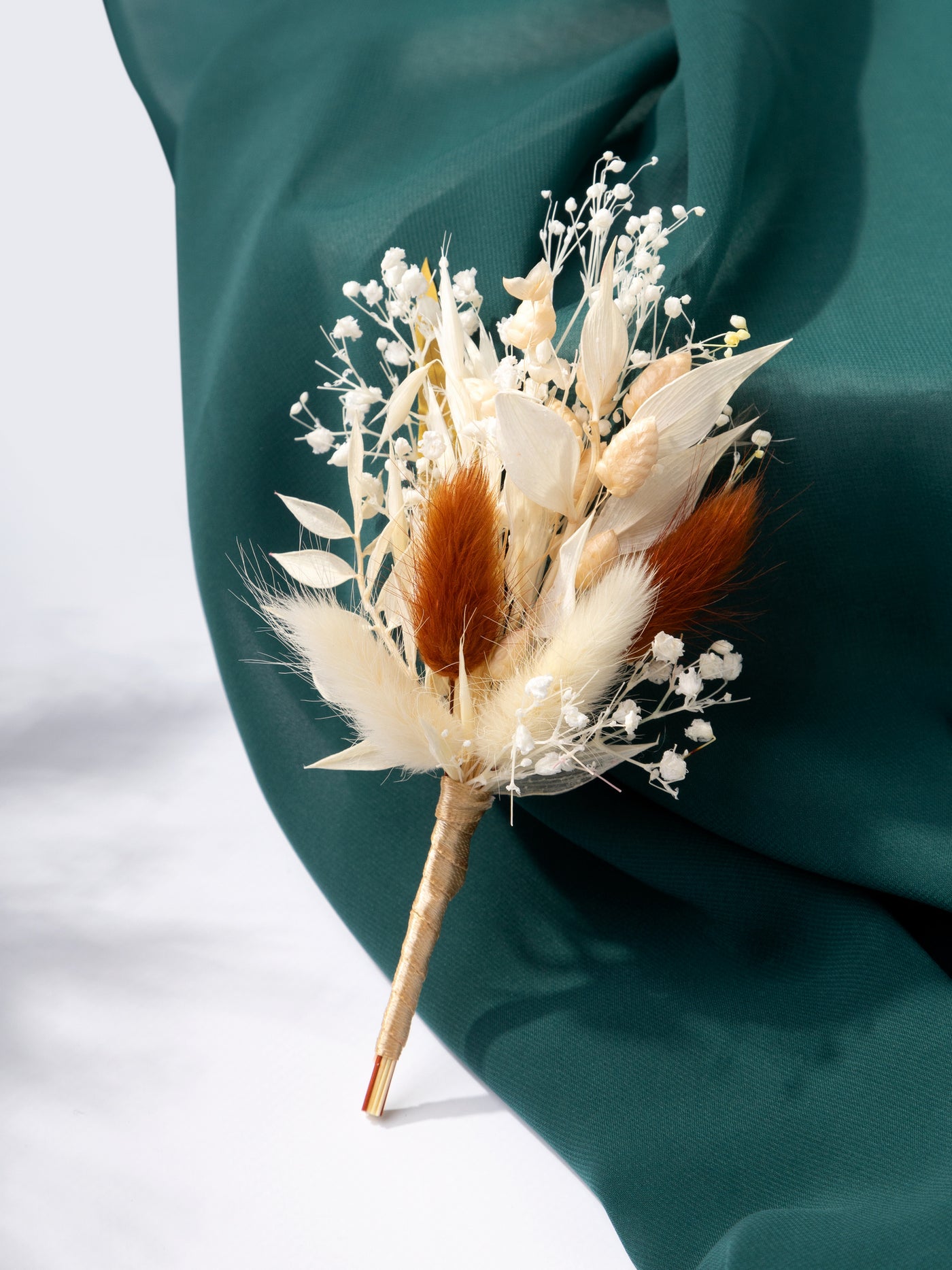 Boutonniere with cream and terracotta dried flowers for groom