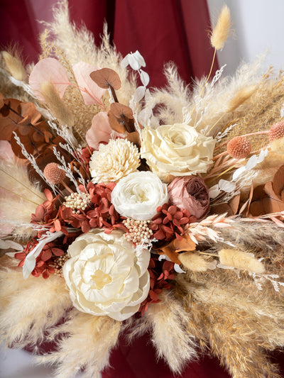 Wedding Table Top With Dusty Rose Flowers, Pampas Grass, And Eucalyptus