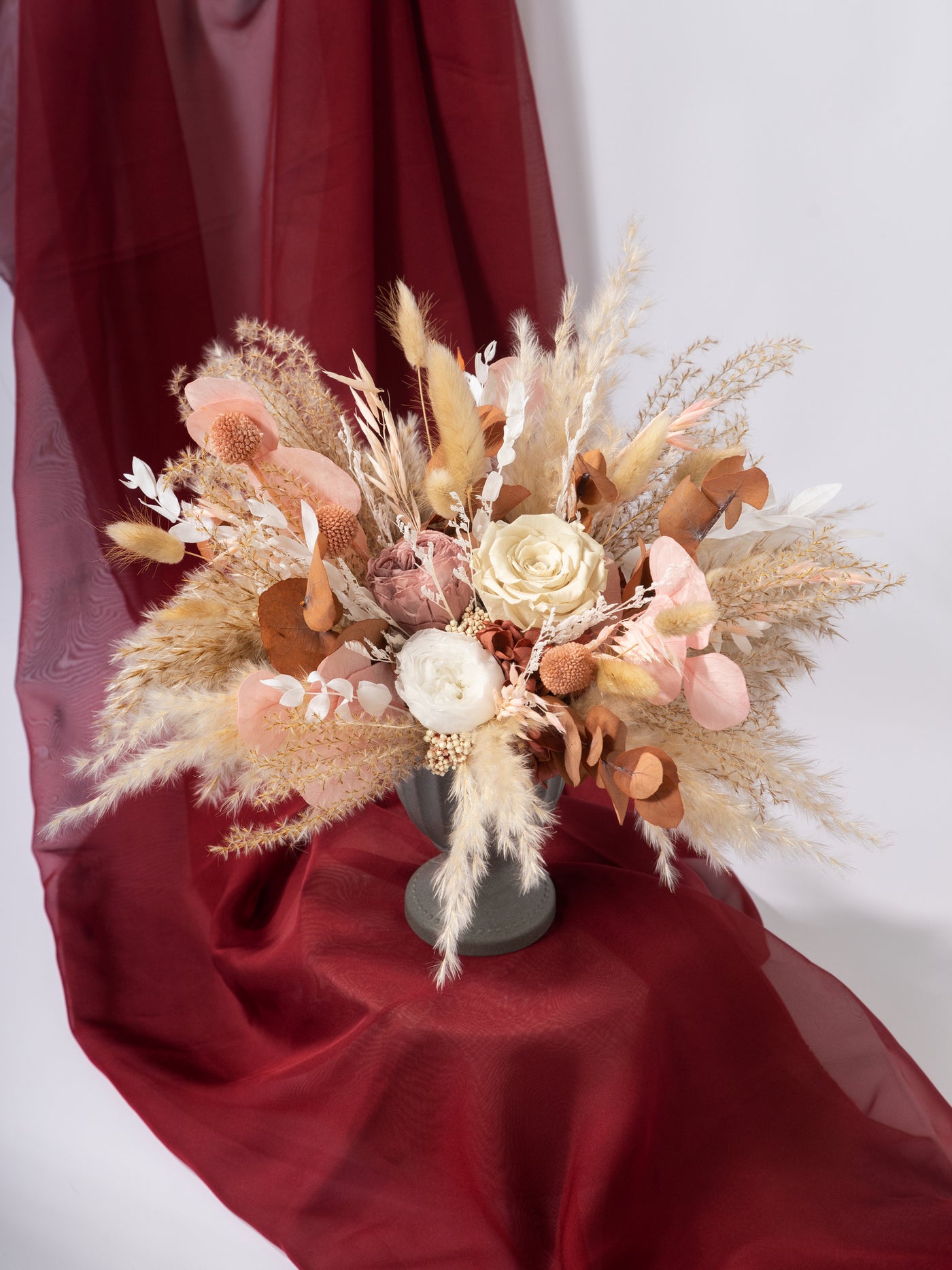 Centerpiece With Dusty Rose Flowers, Pampas Grass, And Eucalyptus