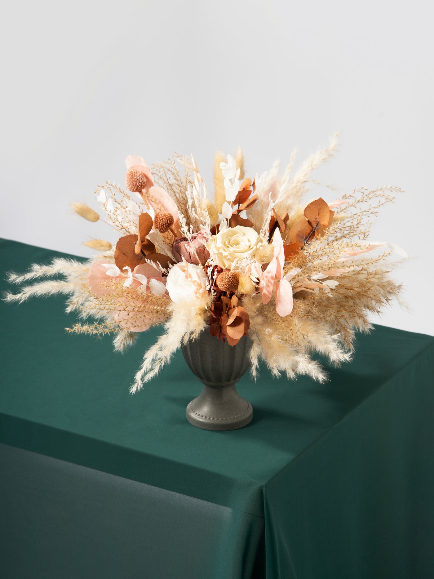 Centerpiece With Dusty Rose Flowers, Pampas Grass, And Eucalyptus