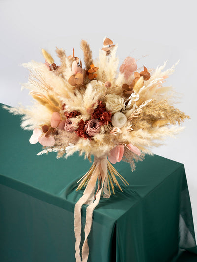 Bridal bouquet with dusty rose flowers, pampas grass, and eucalyptus