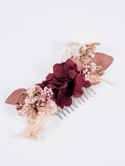 wedding comb with burgundy flower on white background