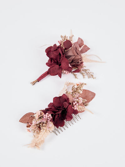 boutonnniere and wedding comb with burgundy flower on white background