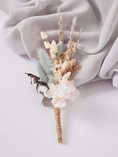 boutonniere on white background and grey silk