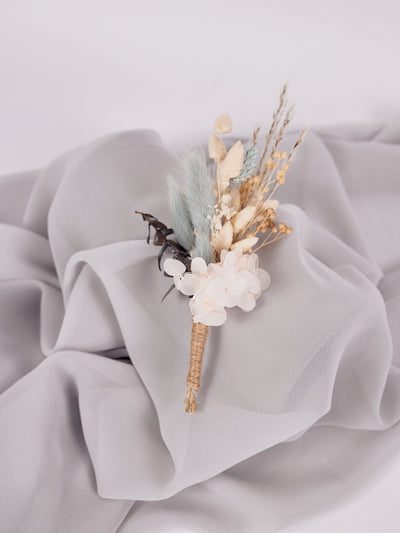 boutonniere is lying on grey fabric