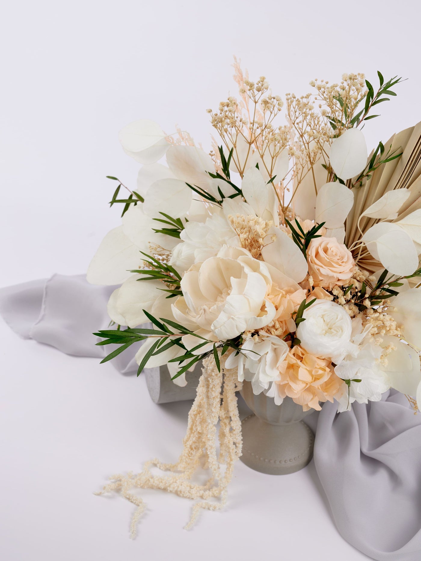 centerpiece is standing near grey fabric on white background 7