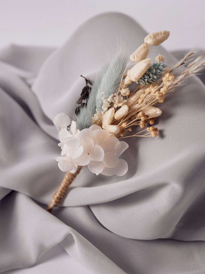 boutonniere is lying on grey fabric 2