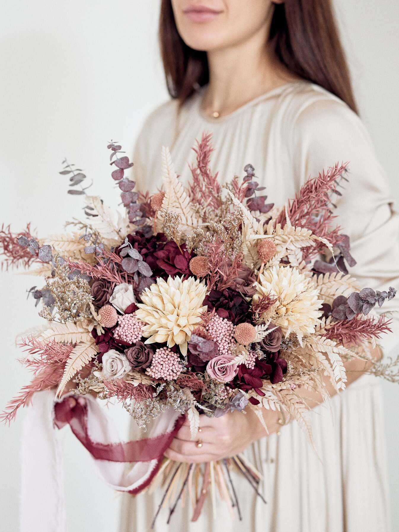 Girl with Bridal burgundy bouquet with dusty flowers