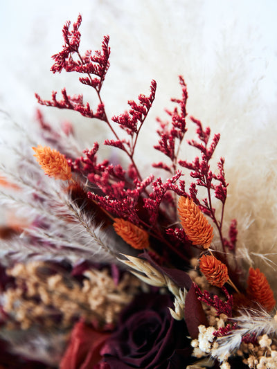 wedding bouquet with burgundy and terracota flowers close-up view