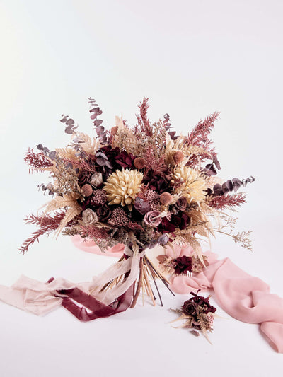 boutonnniere near wedding bouquet on white background