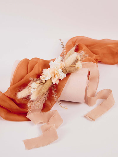 boutonniere lying on the orange fabric