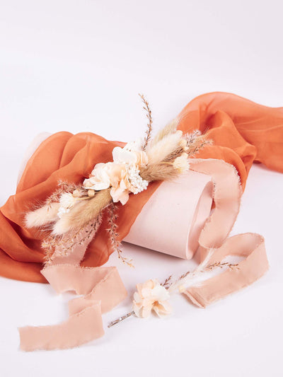 boutonniere lying on the orange fabric 2