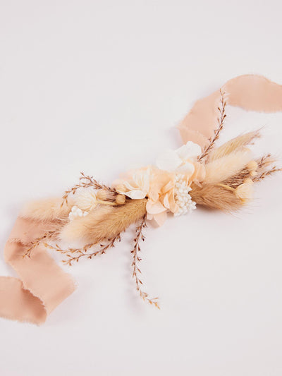 cream boutonniere with branches on white background