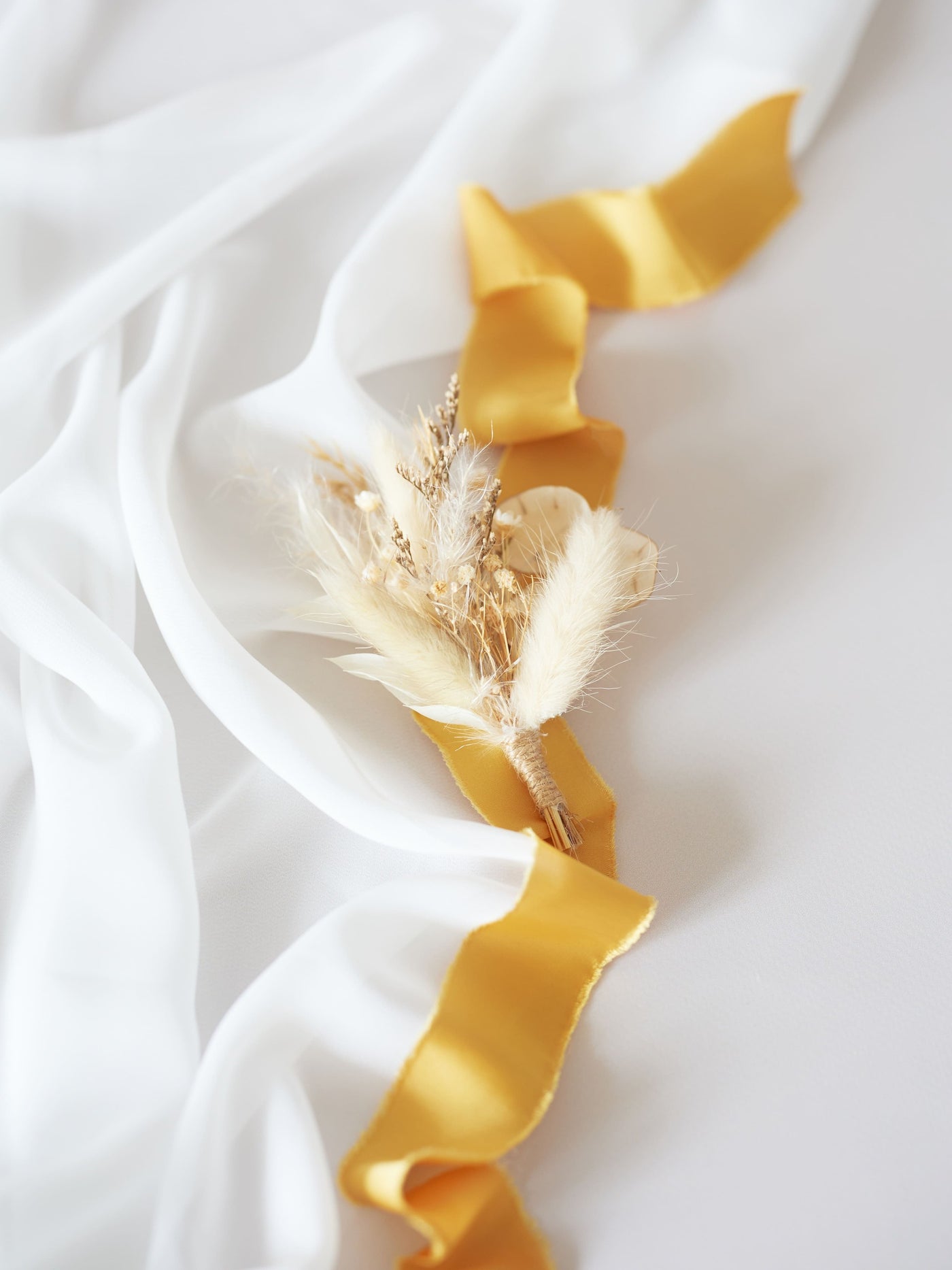 wedding boutonniere on cream ribbon and white organza on white background 2