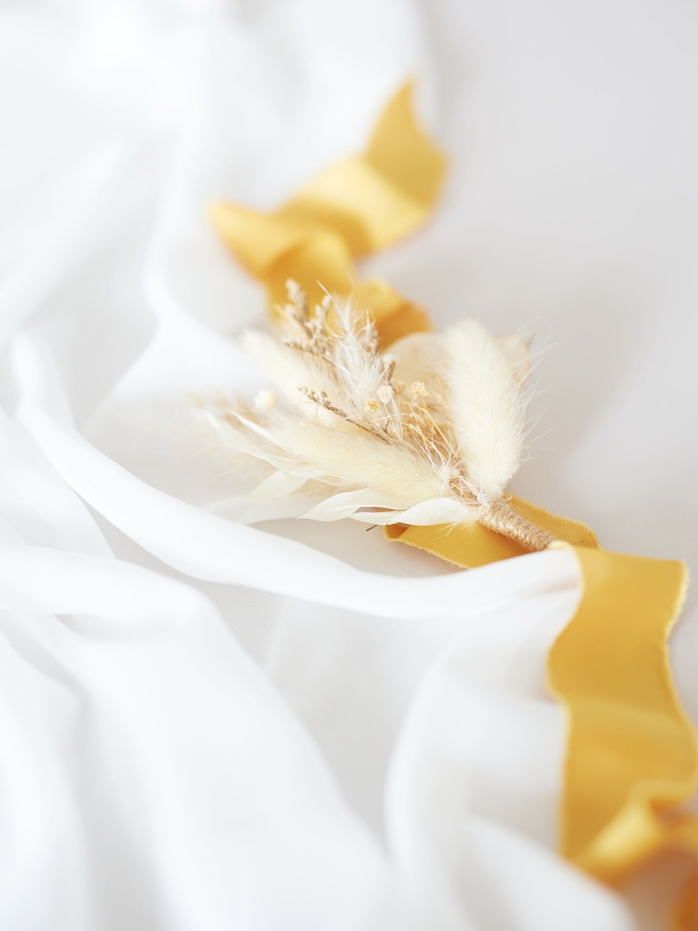 wedding boutonniere on cream ribbon and white organza on white background 3