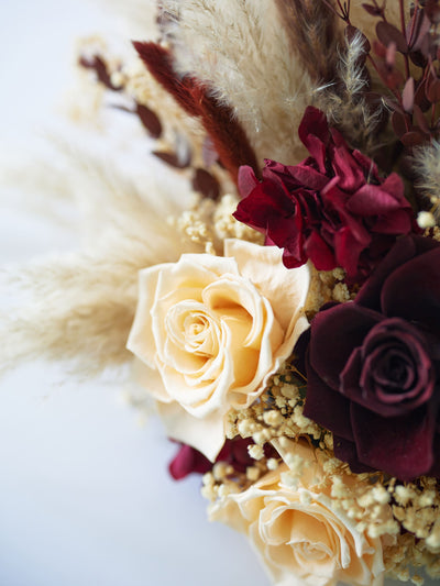 centerpiece with marsala roses , close up view