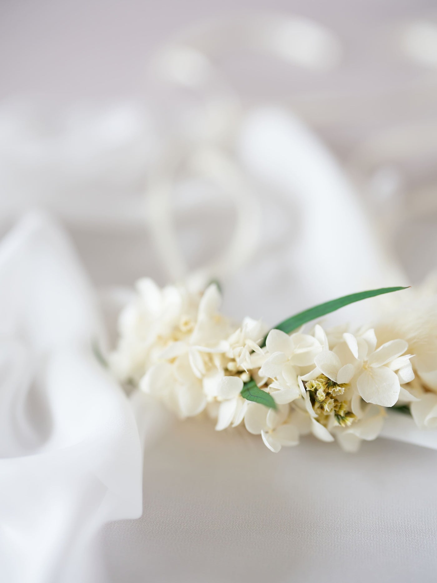 corsage is lying on white organza close up view