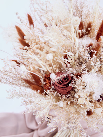 bouquet with rose and dried flowers close up view