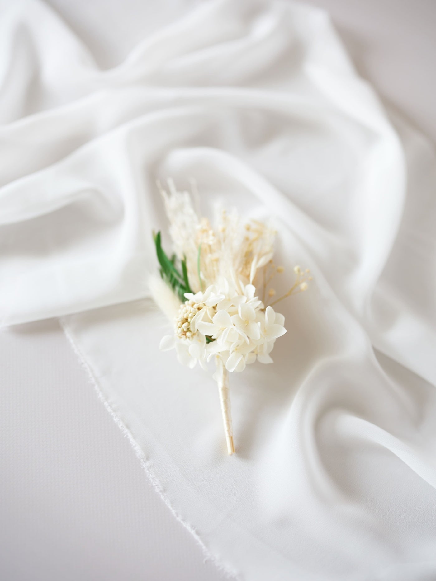 boutonniere is lying on white organza 4