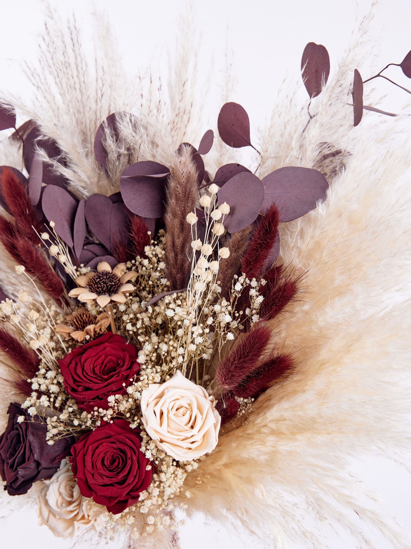 bouquet with marsala and cream roses close up view