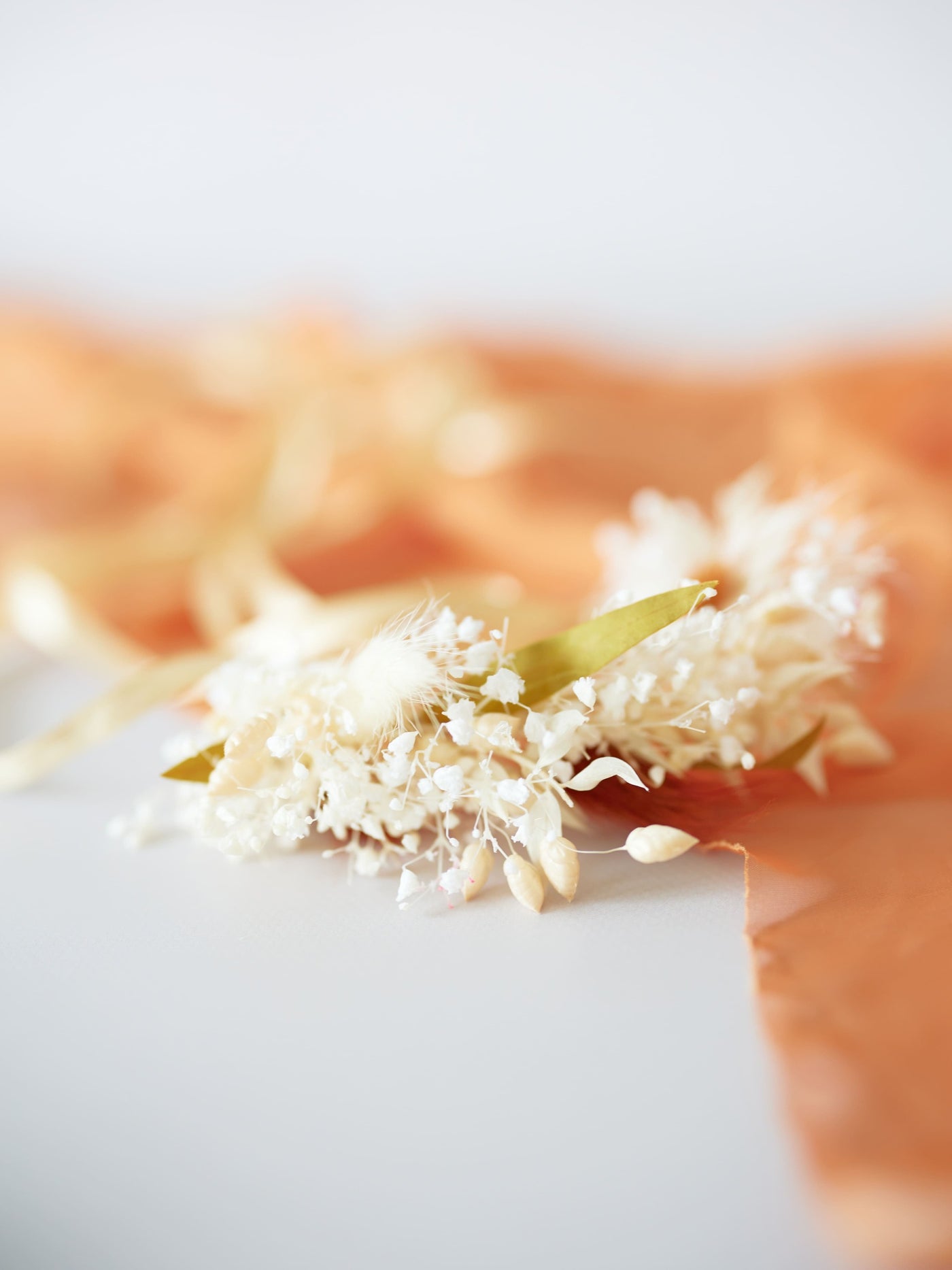 boutonniere on terracotta organza cloth