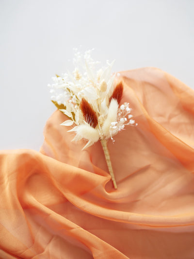 boutonniere on terracotta organza cloth 3