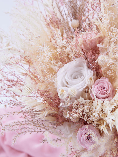 wedding bouquet with roses and dried flowers close up view