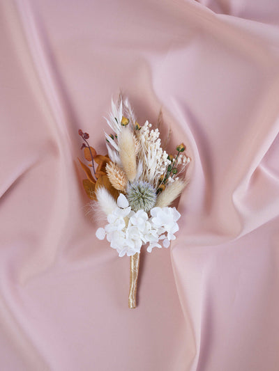 boutonniere is lying on pink fabric