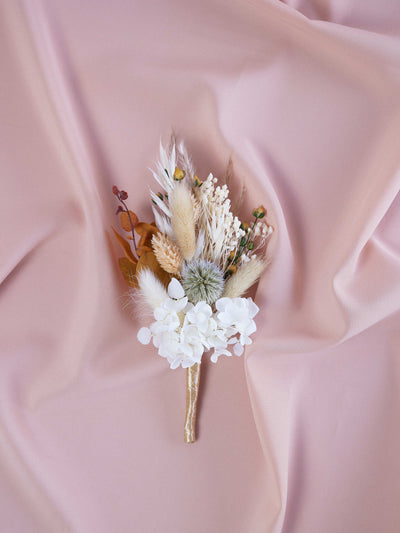 boutonniere lying on the beige fabric