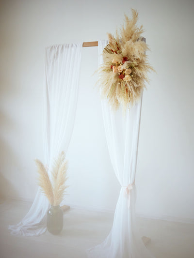 arch flowers bouquet higning on wedding arch with white blinds