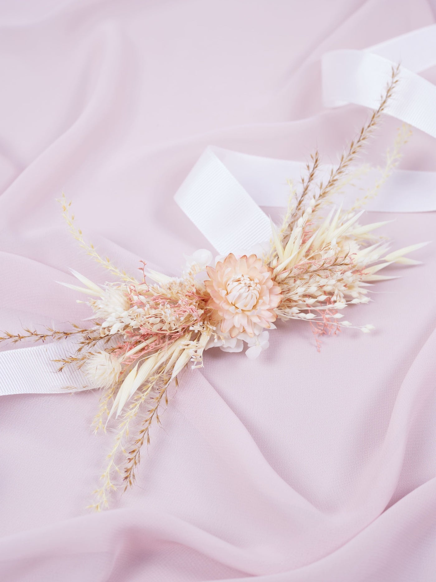 corsage is lying on pink organza