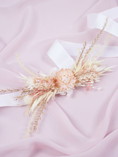 corsage is lying on pink organza