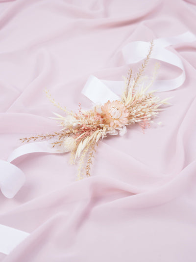 corsage is lying on pink organza