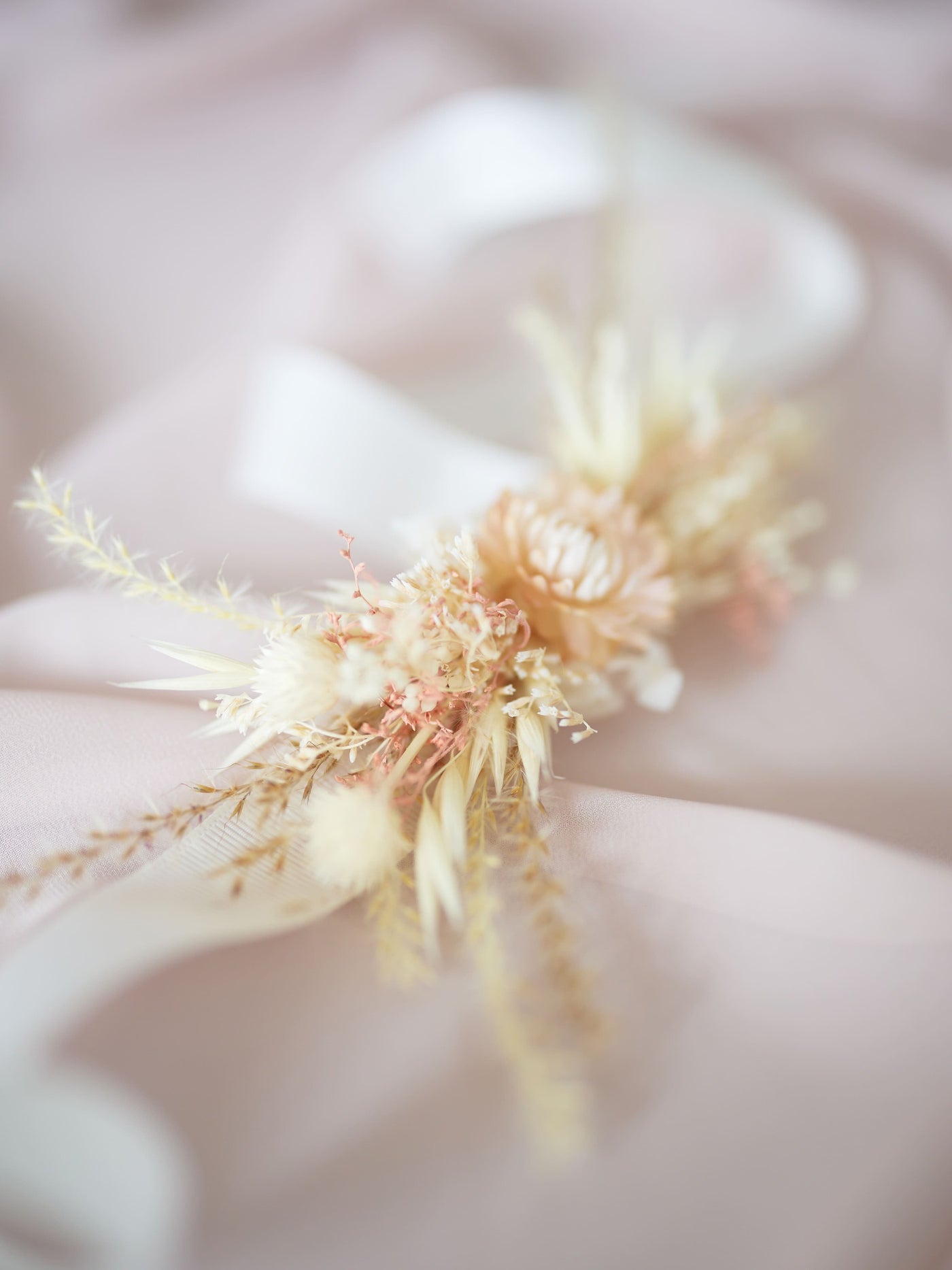 boutonniere lying on pink organza