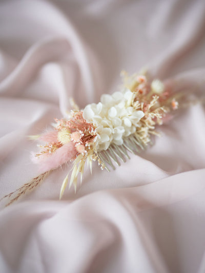 wedding comb is lying on pink organza