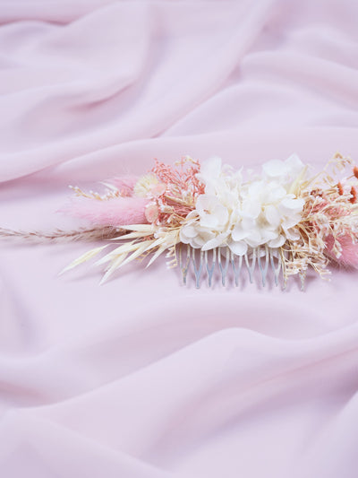 wedding comb is lying on light pink organza 2