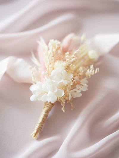 boutonniere is lying on white ribbon and light pink organza 2