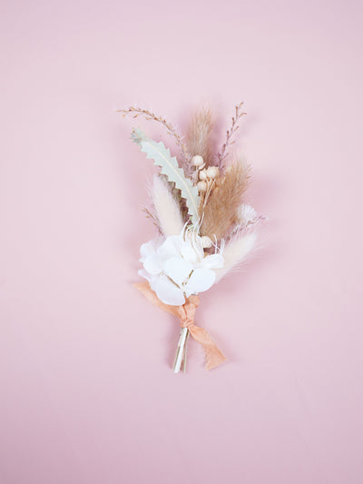 boutonniere is lying on pink background