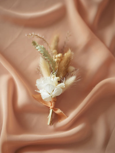 wedding boutonniere is lying on pink organza 2