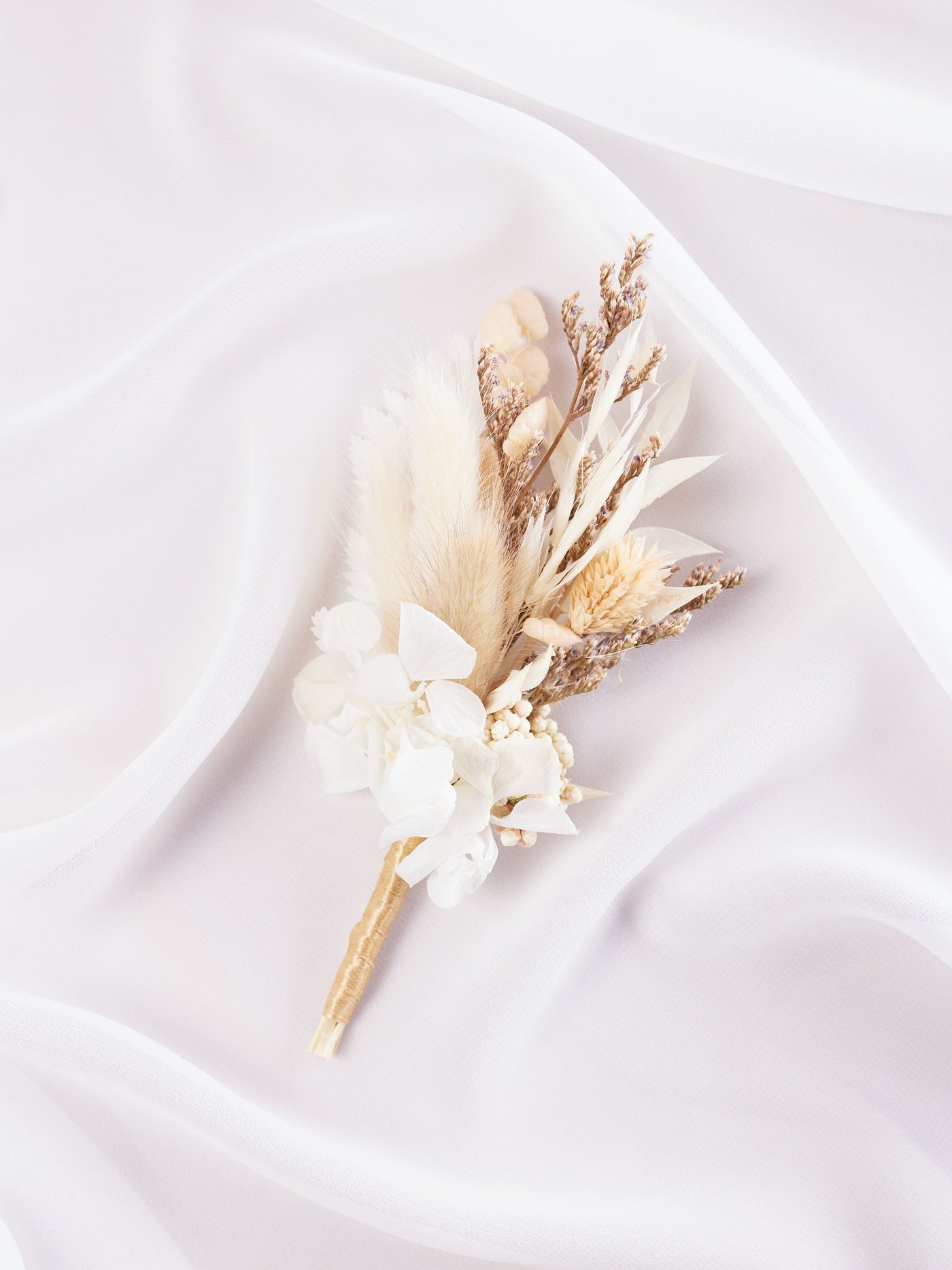 boutonniere is lying on white organza 2